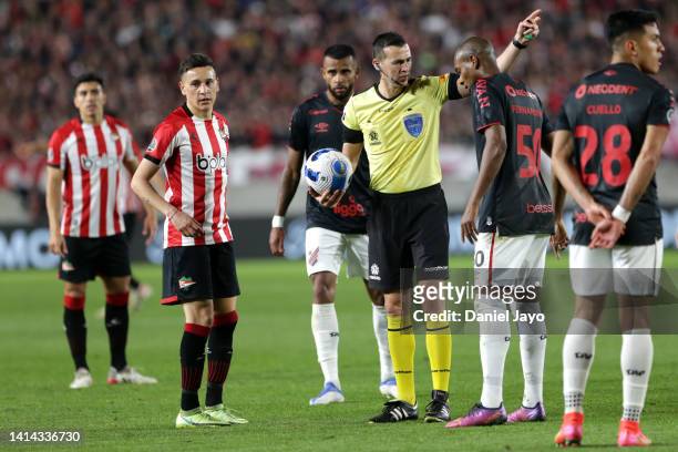Referee Andres Matonte talks to Fernandinho of Athletico-PR during a Copa CONMEBOL Libertadores 2022 quarter final second leg match between...