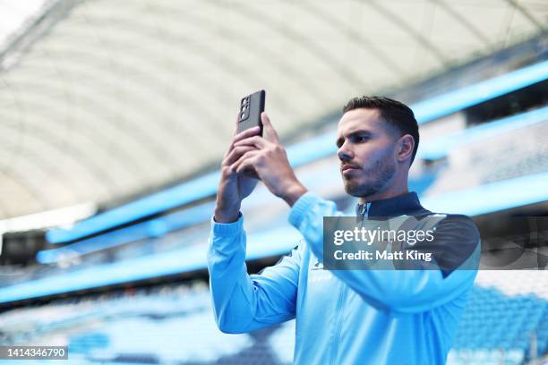 Jack Rodwell records content on his mobile phone during a media opportunity after signing with Sydney FC, at Allianz Stadium on August 12, 2022 in...