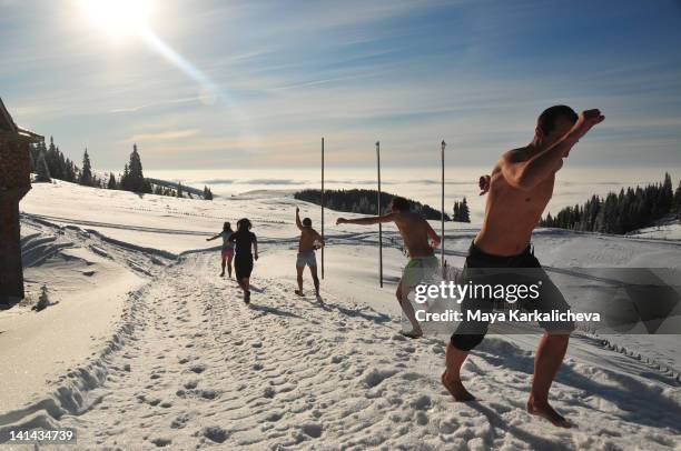 friends running barefoot on snow - barefoot snow stock pictures, royalty-free photos & images