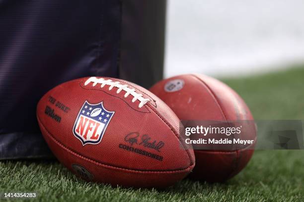 Two practice balls on the field ahead of the the preseason game between the New York Giants and the New England Patriots at Gillette Stadium on...