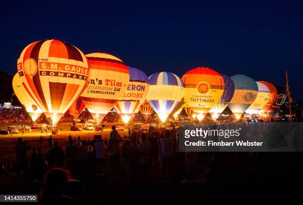 The Night Glow takes place as pilots of hot air balloons light them up in time to music for the crowds at Bristol International Balloon Fiesta at...