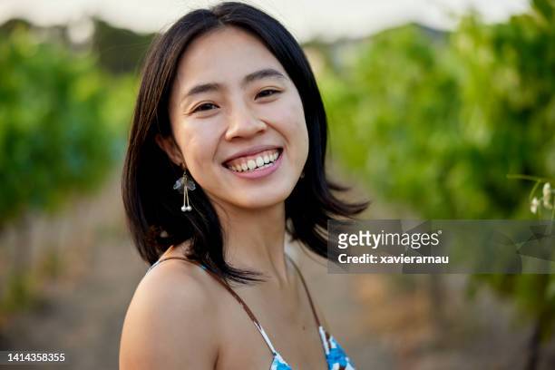 portrait of young chinese woman standing in vineyard - spaghetti strap stock pictures, royalty-free photos & images