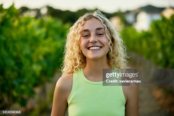 portrait of woman in late teens standing in vineyard - blonde woman imagens e fotografias de stock