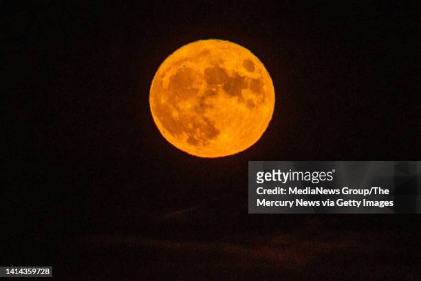 The full Sturgeon Supermoon rises in the horizon seen from Alameda, Calif., on Thursday, August 11, 2022.