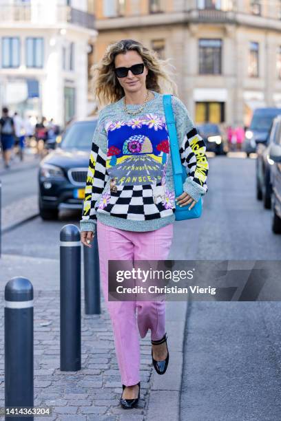 Mija Knezevic is seen wearing pink pants, jumper with print, blue bag outside Saks Potts during Copenhagen Fashion Week Spring/Summer 2023 on August...