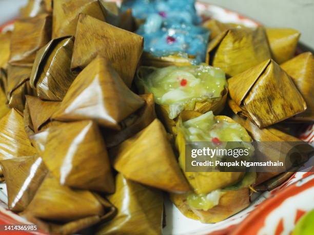 stuffed dough pyramid dessert, stuffed dough pyramid, year cake, chinese new year’s cake, dessert made with glutinous rice flour and sugar put banana leave small basket and steamed cooked - vegetarian food pyramid stock pictures, royalty-free photos & images