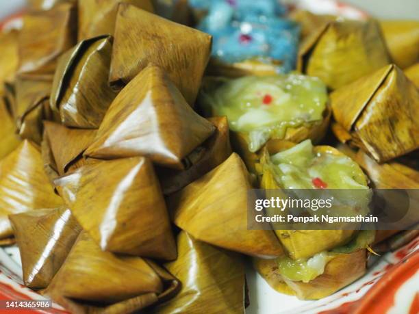 stuffed dough pyramid dessert, stuffed dough pyramid, year cake, chinese new year’s cake, dessert made with glutinous rice flour and sugar put banana leave small basket and steamed cooked - vegetarian food pyramid stock pictures, royalty-free photos & images