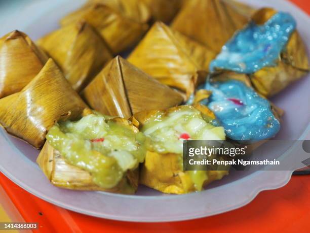 stuffed dough pyramid dessert, stuffed dough pyramid, year cake, chinese new year’s cake, dessert made with glutinous rice flour and sugar put banana leave small basket and steamed cooked - vegetarian food pyramid stock pictures, royalty-free photos & images