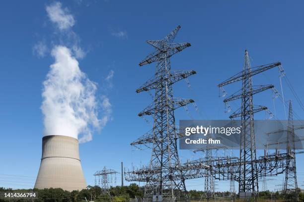 nuclear power plant emsland cooling tower and electricity pylons (lower saxony, germany) - nuclear power station stock pictures, royalty-free photos & images