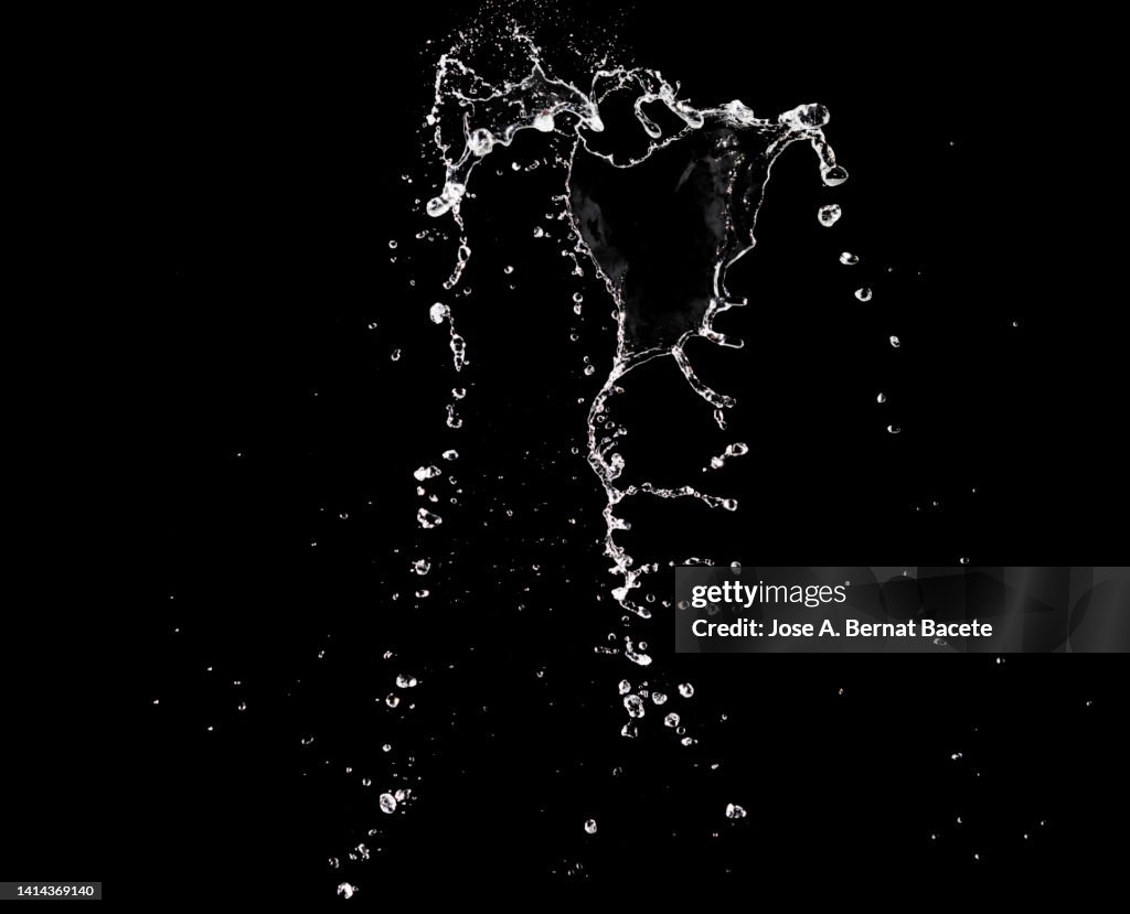 Jets and splashes of water moving up on a black background.