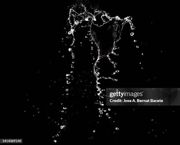 jets and splashes of water moving up on a black background. - queda de água imagens e fotografias de stock