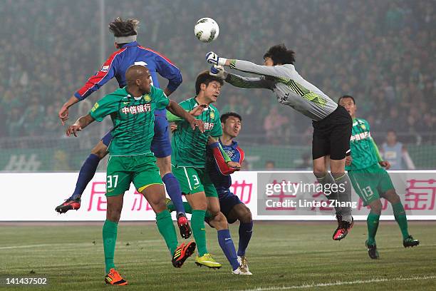 Wang Dalei of Shanghai Shenhua makes a save from Australia International player Da Costa Reinaldo Elias of Beijing Guoan during the Chinese Super...