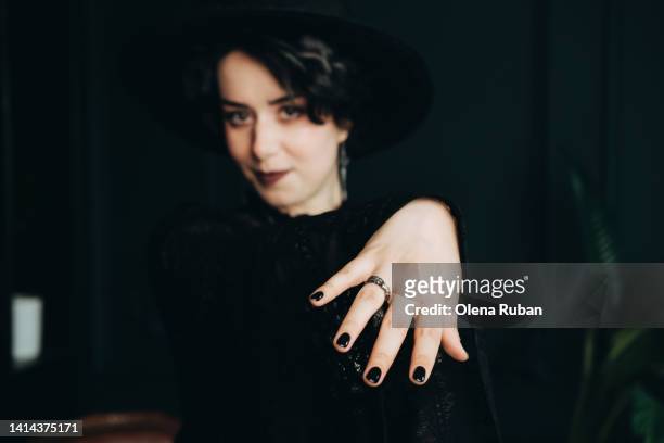 young woman in black dress showing wedding ring. - black nail polish stock pictures, royalty-free photos & images