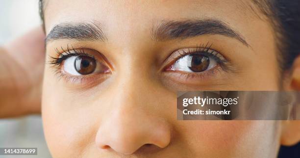 woman looking into camera - eyebrow stock pictures, royalty-free photos & images