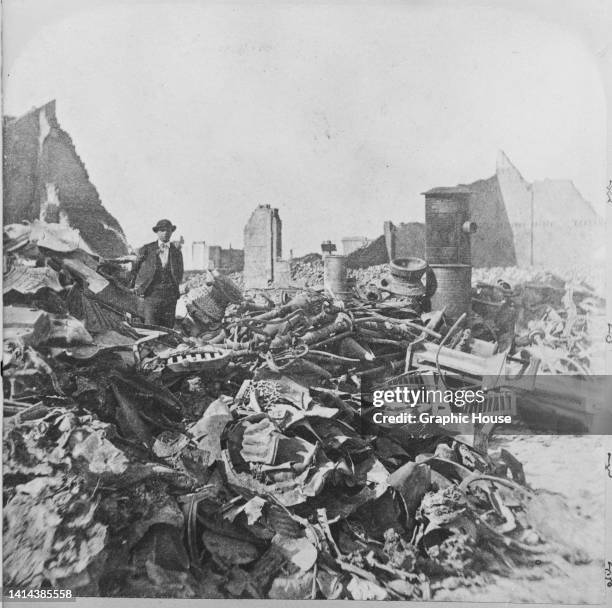 Man standing among rubble and melted debris after the Great Chicago Fire, Chicago, Illinois, October 1871. The Great Chicago Fire, which burned from...