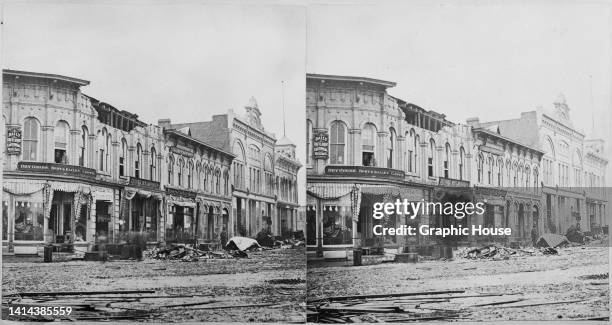 Stereoscopic image showing damage to the 'Daily Outlook Editorial Rooms,' 'Bort & Bailey' dry goods and carpets, and 'Travers Clothing House,' among...