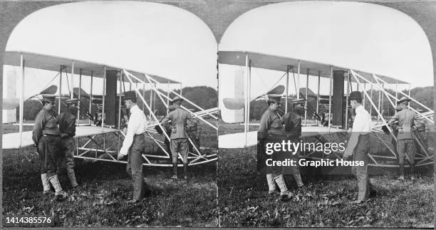 Stereoscopic image showing the Wright brothers and Army Signal Corps personnel prepare the Wright Military Flyer for its test flight at Fort Myer,...