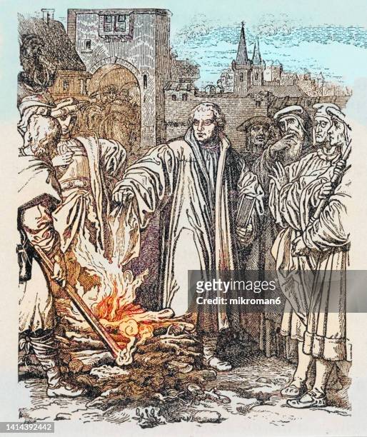 engraving illustration of of martin luther burns the papal bull in wittenberg - martin luther reformation luther stock pictures, royalty-free photos & images