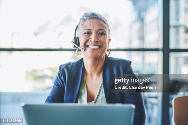 smiling, happy and mature female customer service support worker talking online on a computer. call centre agent with a headset doing web help. woman telemarketer working on internet assistance - headset imagens e fotografias de stock