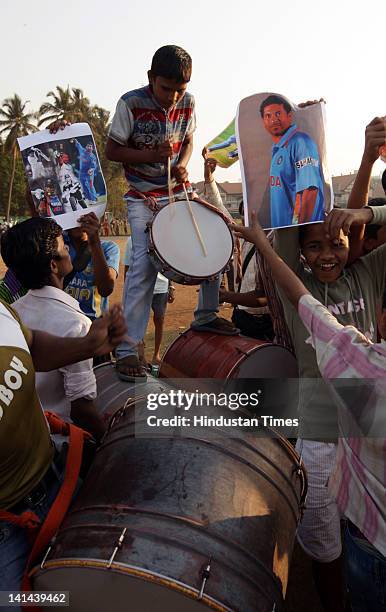 Fans celebrate after Sachin Teldulkar of India scored his 100th century in international cricket at Sher-e-Bangla Stadium on March 16, 2012 in...