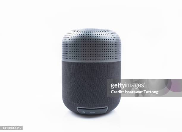 portable wireless speaker isolated on white background. black sound speaker with ribbed texture and control buttons. vertical position. front view. - bluetooth fotografías e imágenes de stock
