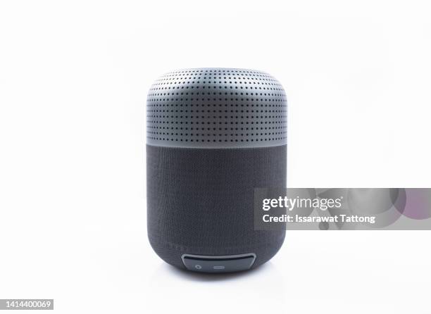 portable wireless speaker isolated on white background. black sound speaker with ribbed texture and control buttons. vertical position. front view. - bluetooth photos et images de collection