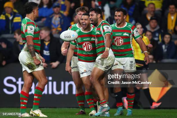Alex Johnston of the Rabbitohs celebrates with team mates after scoring a try during the round 22 NRL match between the Parramatta Eels and the South...