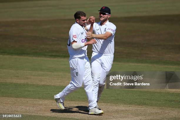 Sam Conners of England Lions celebrates taking the wicket of Ryan Rickelton of South Africa caught by Sam Billings with Sam Cook during day four of...