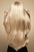Back view of woman with long beautiful blond hair