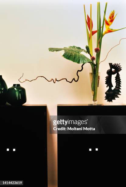 Flowers at home, Flowers Design, helyconia wagneriana, globemaster alium, alocasia leaf and twisted hazel branch.