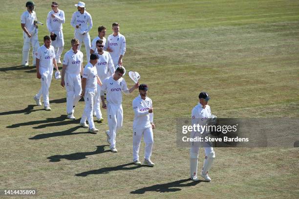 The England Lions players are led off the field by Sam Billings after their victory over South Africa during day four of the tour match between...