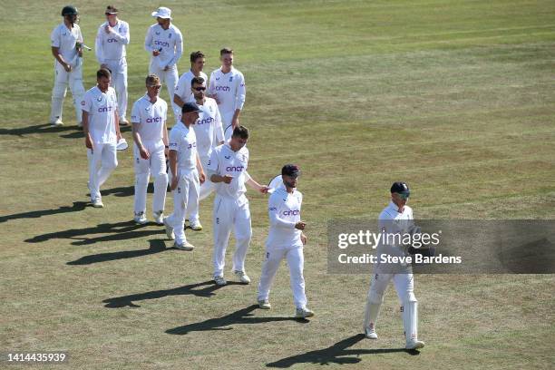 The England Lions players are led off the field by Sam Billings after their victory over South Africa during day four of the tour match between...