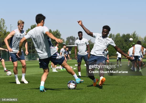 Takehiro Tomiyasu and Bukayo Saka of Arsenal during a training session at London Colney on August 12, 2022 in St Albans, England.