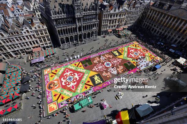 In this aerial view, volunteers lay down flowers to assemble a giant flower carpet within the celebrations to mark it's 50th anniversary at Grand...