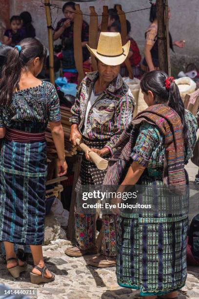 Guatemala, El Quiche Department, Chichicastenango, A Mayan man in the distinctive outfit from Solola in the Indian market, including a heavy wool...