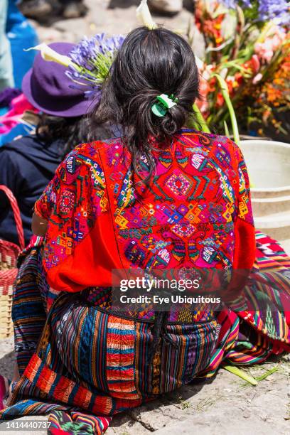 Guatemala, El Quiche Department, Chichicastenango, A woman at the Sunday market wears the traditional colorful woven huipil or blouse from that town.