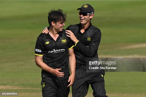 Gloucestershire bowler Tom Price is congratulated by Oliver Price after taking the wicket of Graham Clark during the Royal London Cup match between...