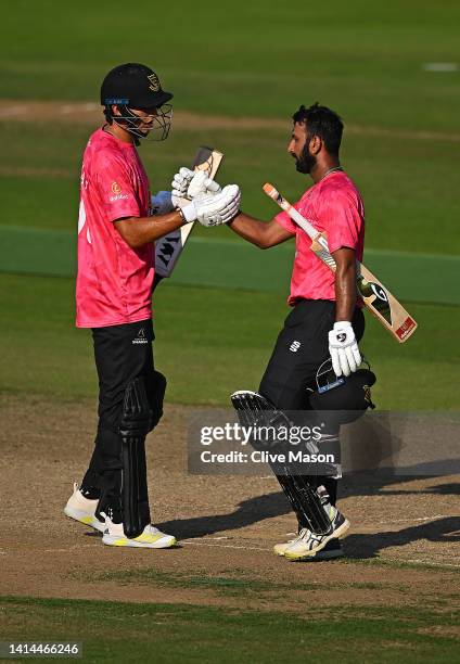 Cheteshwar Pujara of Sussex Sharks celebrates his century with team mate Aristides Karvelas during the Royal London One Day Cup match between...