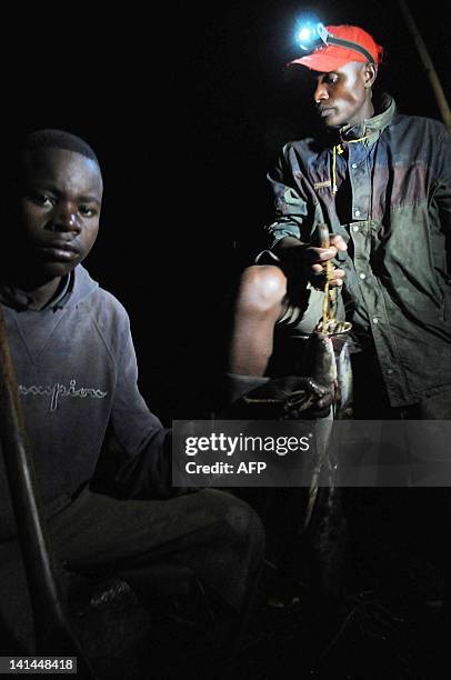 By Steve Terrill Rwandan fisherman, Daniel Ntibaziyandemye and his helper, Jean Pierre, use a rechargeable LED light to display their catch in...