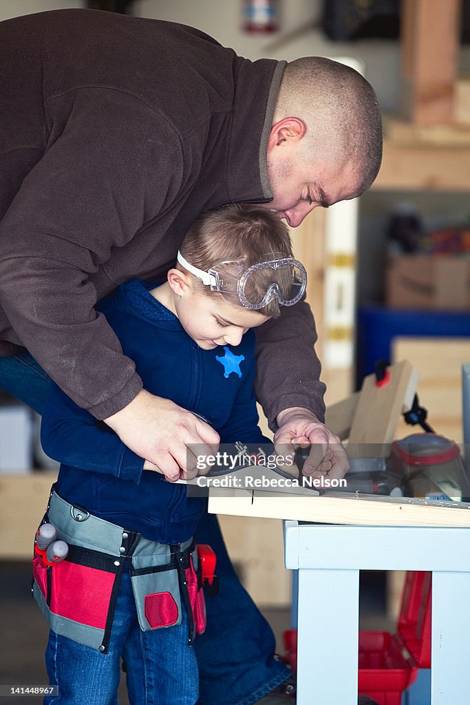 Father helping his young son