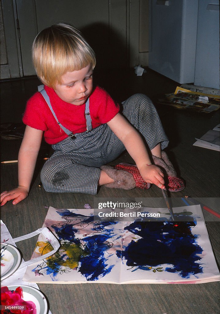 Child painting with watercolors