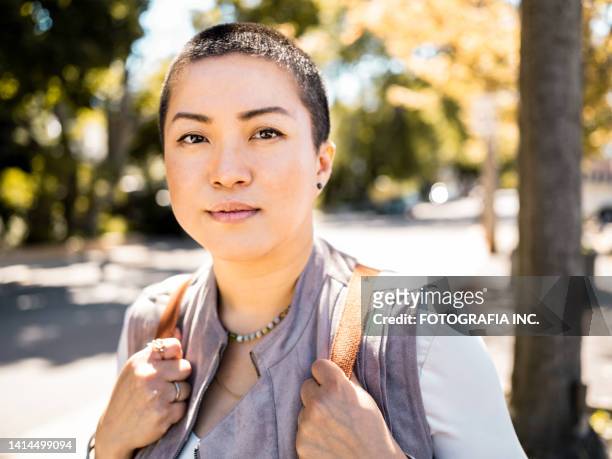 young asian woman walking on the city street - fat lesbian stockfoto's en -beelden