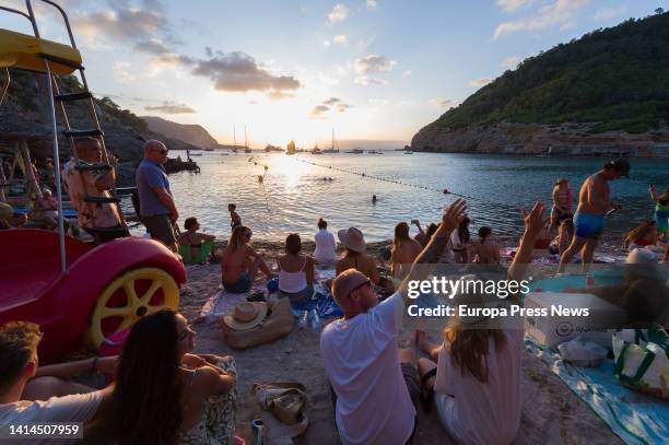 Bathers enjoy themselves at Cala Benirras, on July 28 in Ibiza, Balearic Islands, Spain. The Benirras cove, even being in the north, has a west...