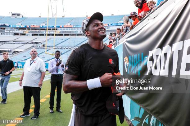 Quarterback Deshaun Watson of the Cleveland Browns talk with fans before the start of a preseason game against the Jacksonville Jaguars at TIAA Bank...