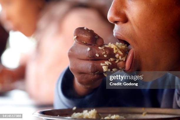 Rehabilitation center for street children. Boy eating lunch..