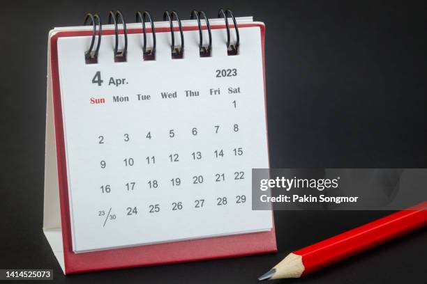 calendar desk 2023 april is the month for the organizer to plan and red pencil with a black background. - april fools day stock pictures, royalty-free photos & images