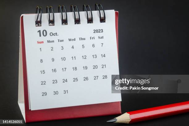 calendar desk 2023 october is the month for the organizer to plan and red pencil with a black background. - outubro imagens e fotografias de stock