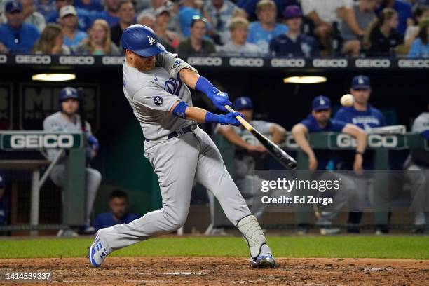 Justin Turner of the Los Angeles Dodgers hits a sacrifice fly in the seventh inning against the Kansas City Royals at Kauffman Stadium on August 12,...