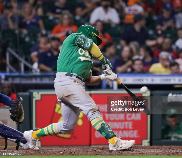Vimael Machin of the Oakland Athletics singles in the seventh inning against the Houston Astros at Minute Maid Park on August 12, 2022 in Houston,...