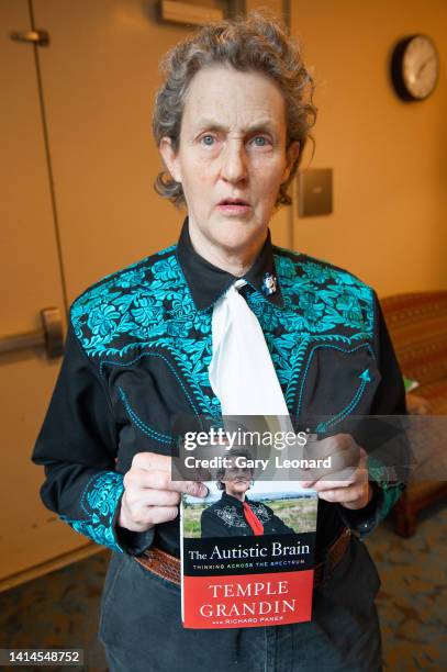 During the Aloud series at the Los Angeles Central Library scientist Temple Grandin poses for a portrait in a turquoise cowboy shirt with her book...